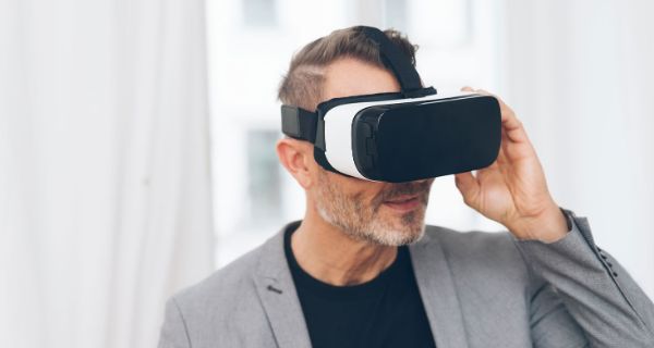 Mann im Anzug trägt eine VR-Brille